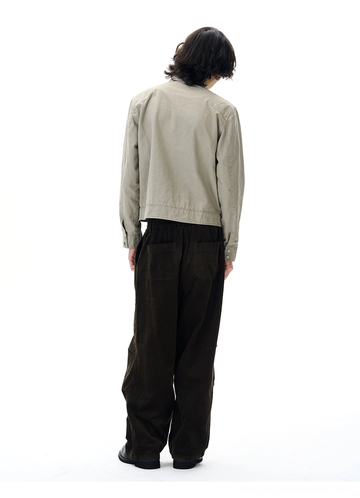 Gray cropped utility jacket back view with clean cotton workwear design and wide-leg brown trousers