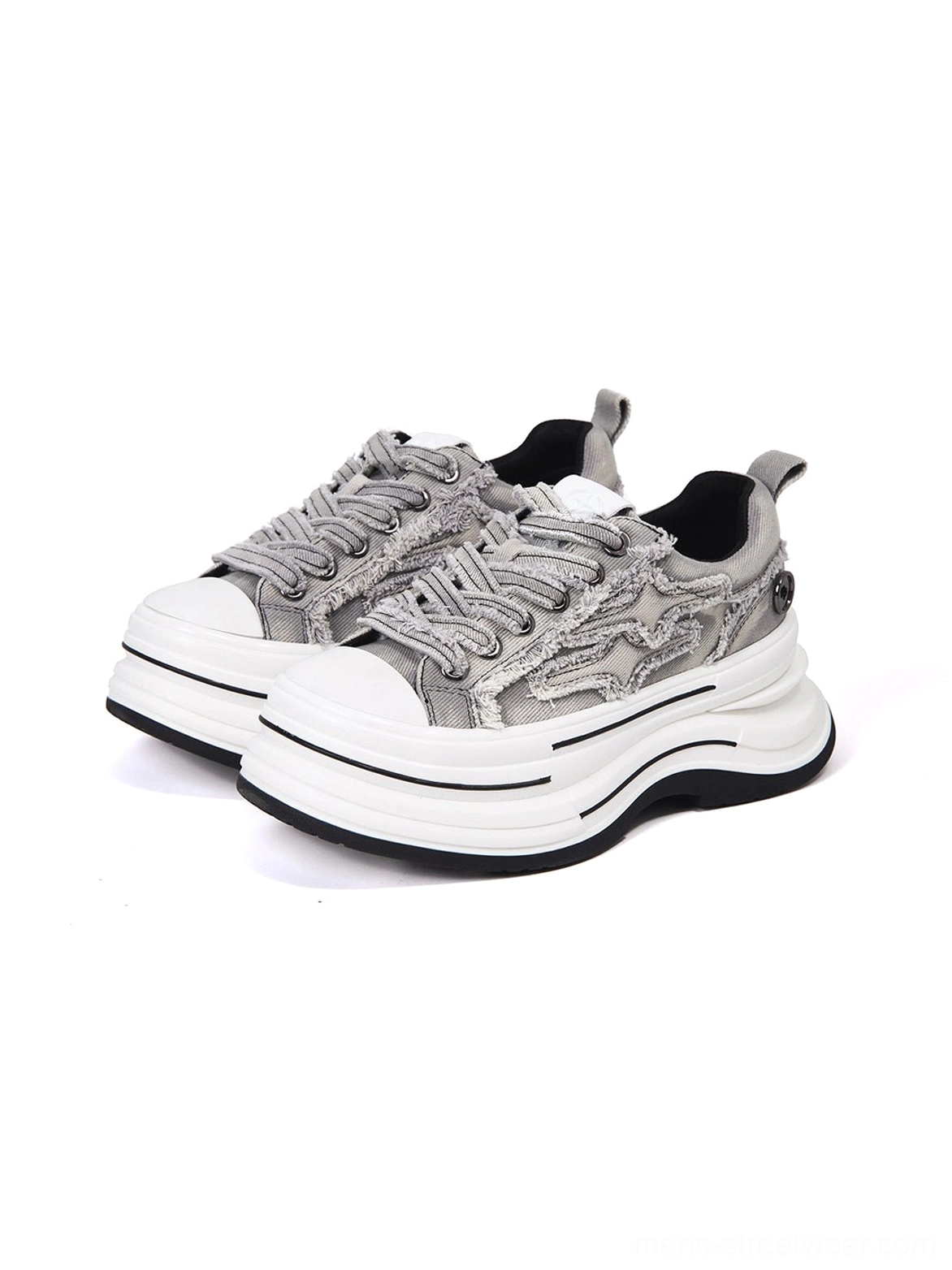 Front three-quarter view of gray frayed canvas platform sneakers showing both shoes, raw edge upper details, textured laces, and layered white platform sole