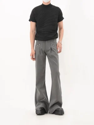 Front full body view of gray high waisted studded flare trousers with pleated tailoring and long legs styled for Seoul streetwear