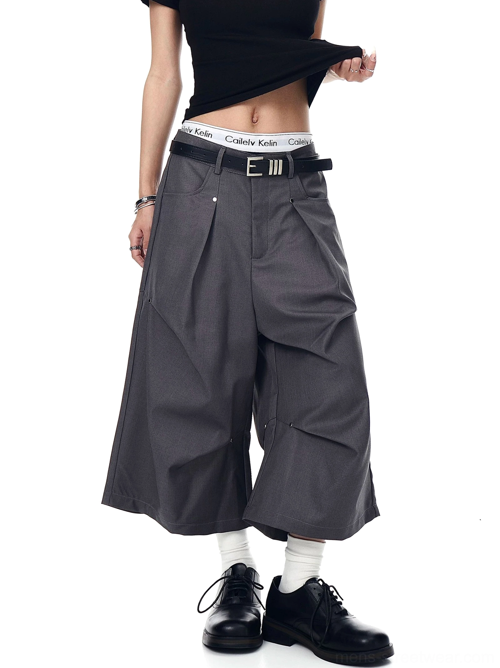 Gray Korean streetwear longline shorts with deep front pleats, exposed waistband styling, and a wide tailored cut