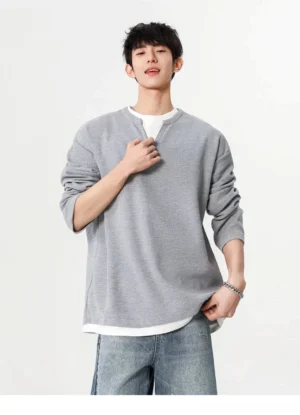 Gray Korean streetwear waffle texture faux layered relaxed sweatshirt shown from the front with drop shoulders and long sleeves