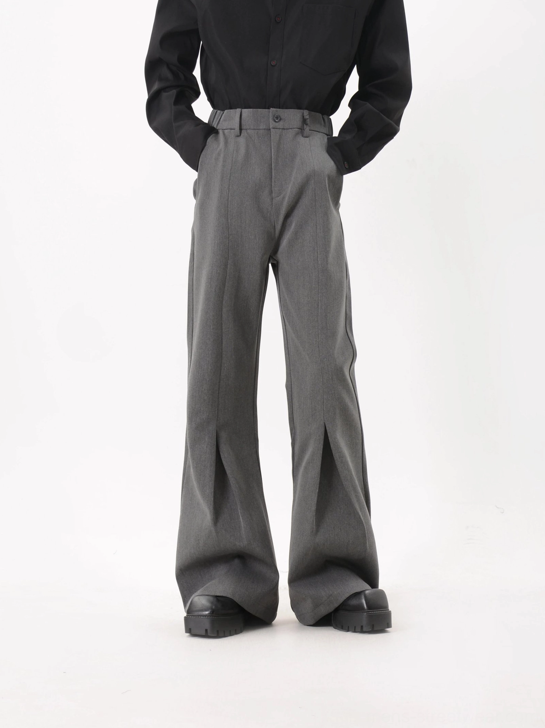 Gray Korean tailored streetwear trousers with front sculpted creases and dramatic flared silhouette