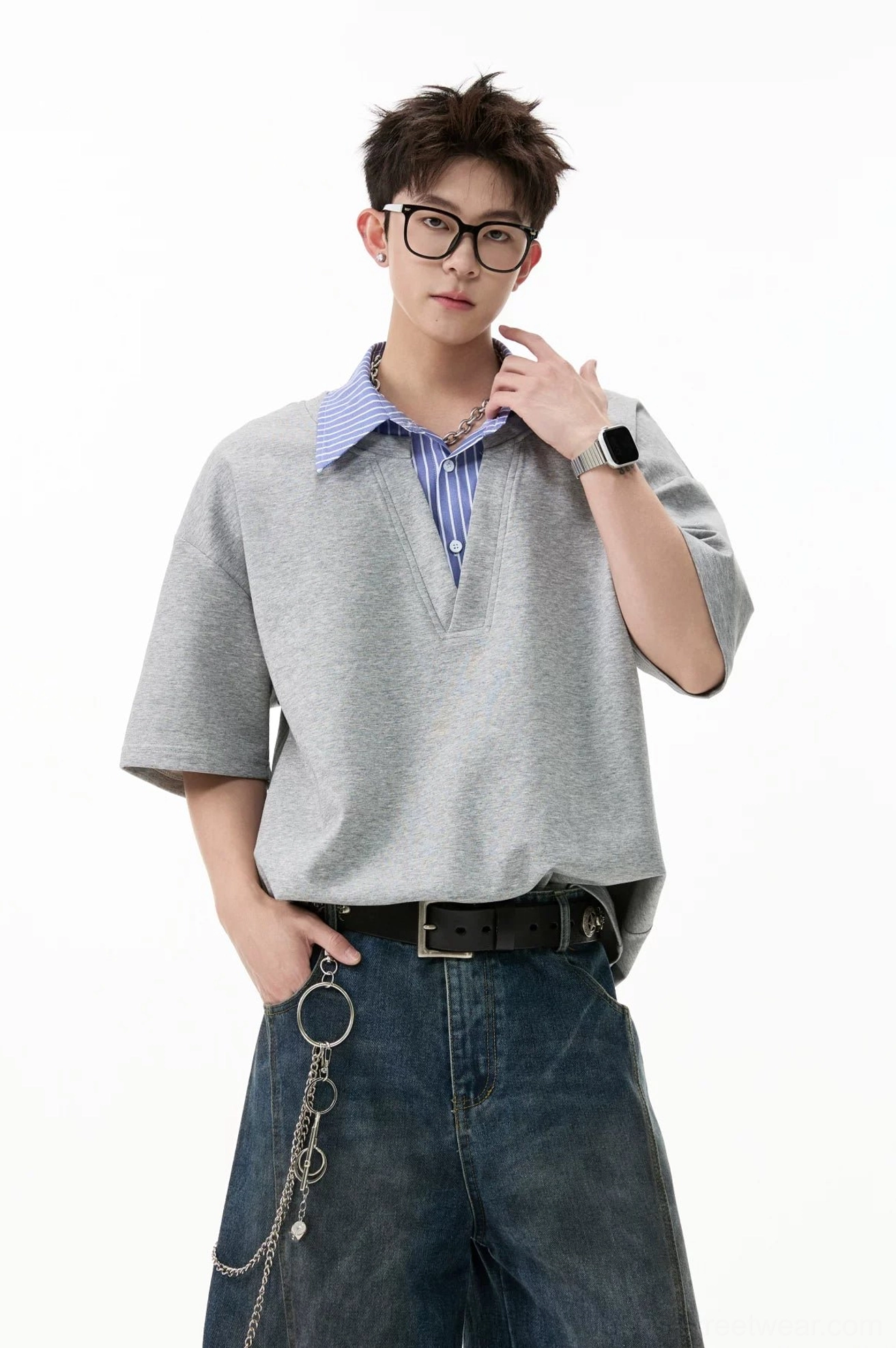 Gray layered V-placket oversized polo tee close-up showing contrasting purple-blue striped collar and relaxed fit