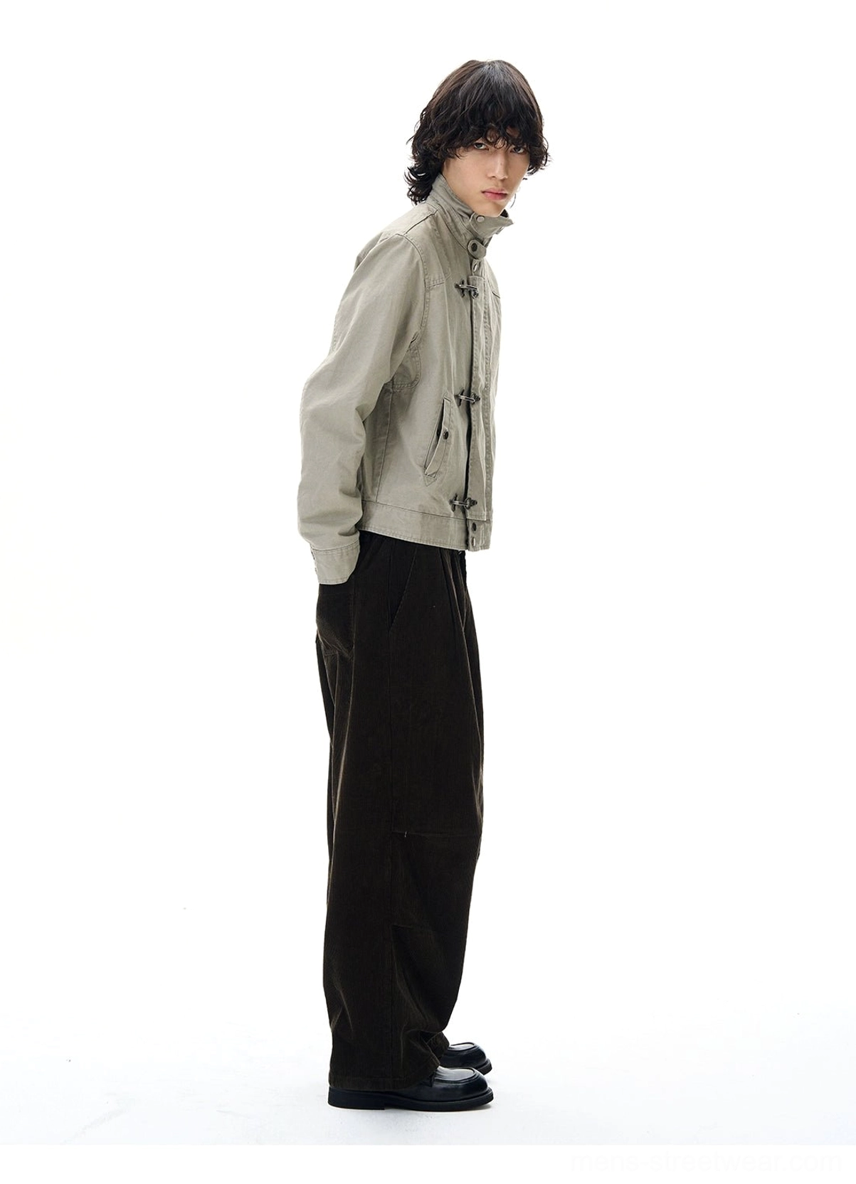 Gray metal toggle utility jacket side profile showing structured collar cropped length and tailored workwear fit