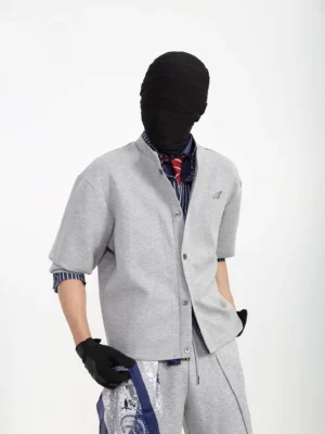 Heather gray minimal snap front cardigan jacket styled with a striped shirt, red tie, black gloves, and matching streetwear sweatpants