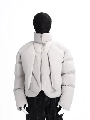 Gray nebula sculpted cropped puffer jacket front three-quarter view showing draped shield-like padded front panels and stand collar