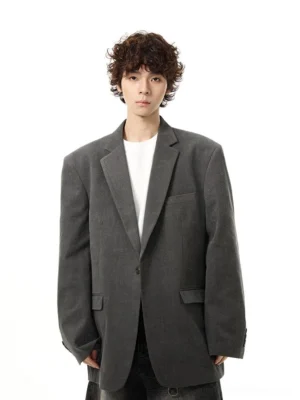 Gray oversized casual tailored blazer with notched lapel and button cuffs shown in straight front view