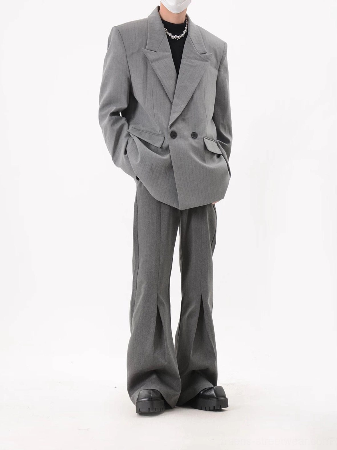 Three-quarter view of gray oversized pinstripe double-breasted blazer with structured shoulders and relaxed longline fit
