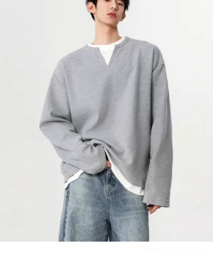 Gray oversized waffle texture sweatshirt with faux layered white hem styled with jeans in a relaxed Korean streetwear outfit
