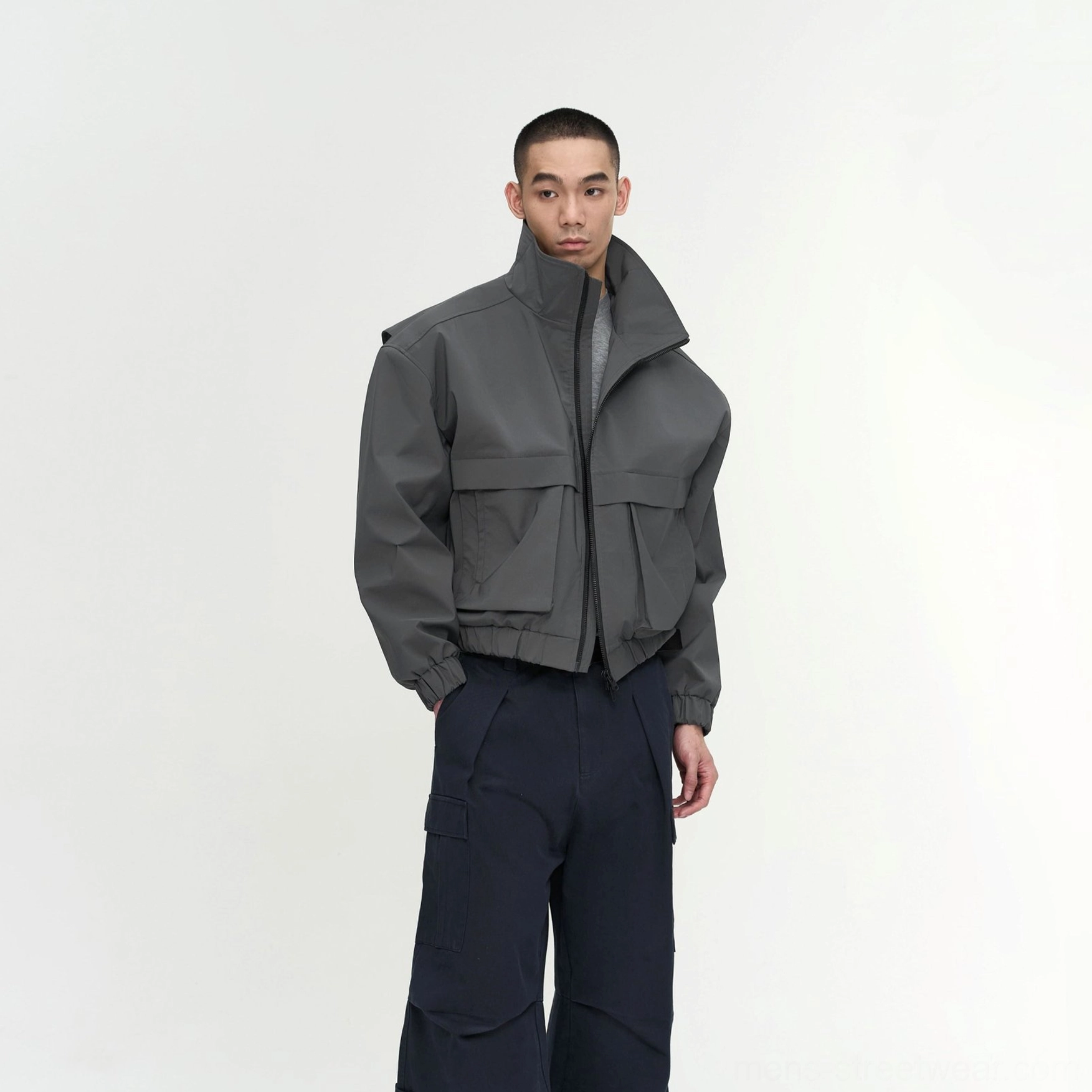 Men's gray padded stand-collar utility jacket with relaxed boxy cropped fit and front flap pockets in modern Korean streetwear style