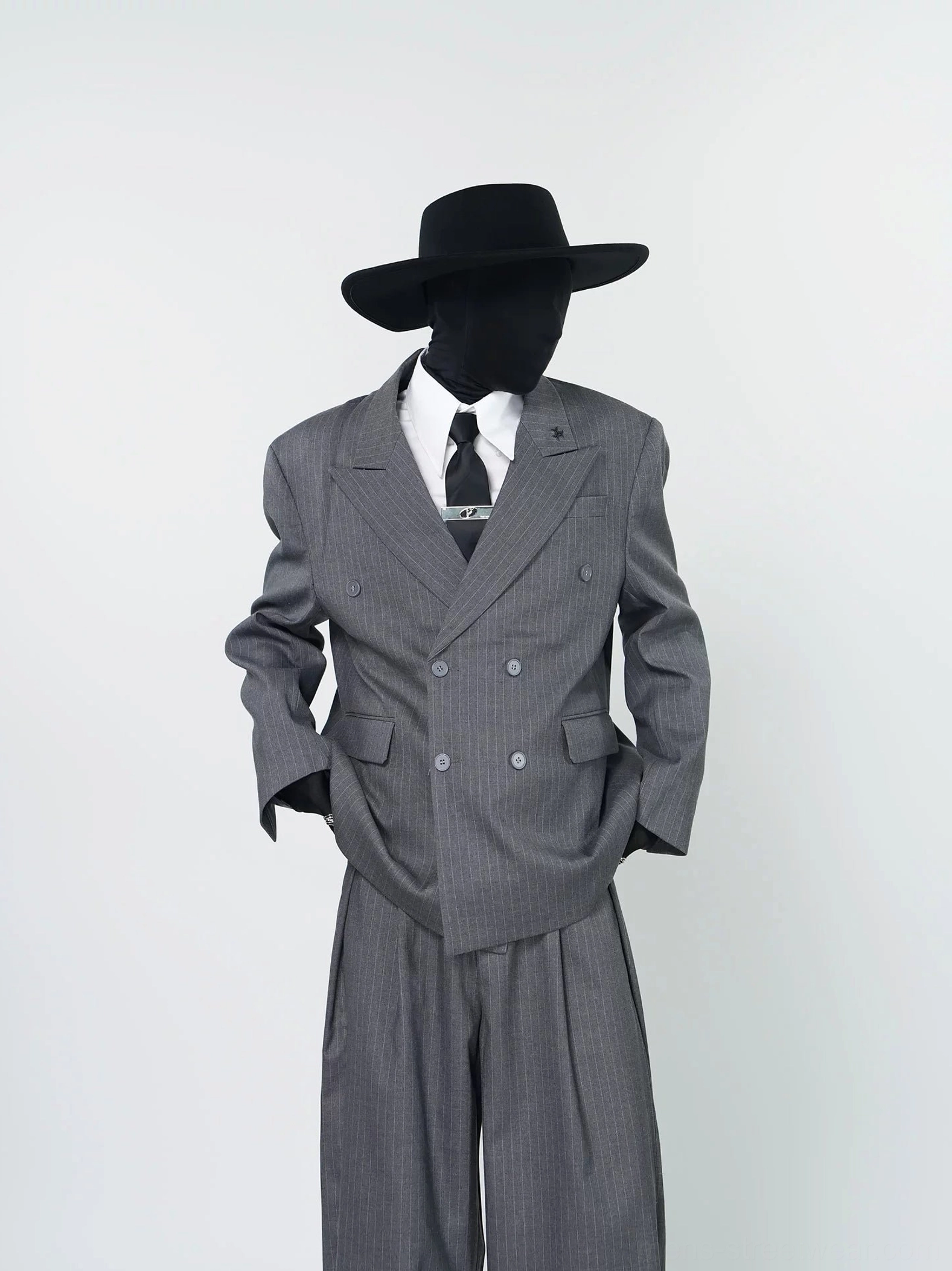 Front view of gray pinstripe double-breasted blazer and pleated wide-leg trousers in Korean streetwear tailoring style