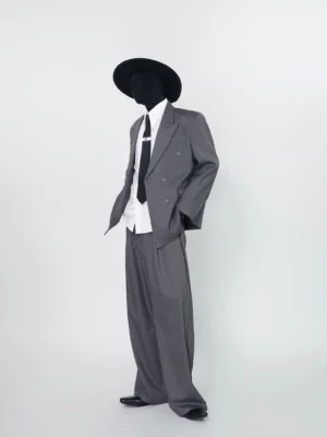 Gray pinstripe double-breasted blazer and wide-leg trouser set styled with white shirt black tie and cowboy hat left full body view