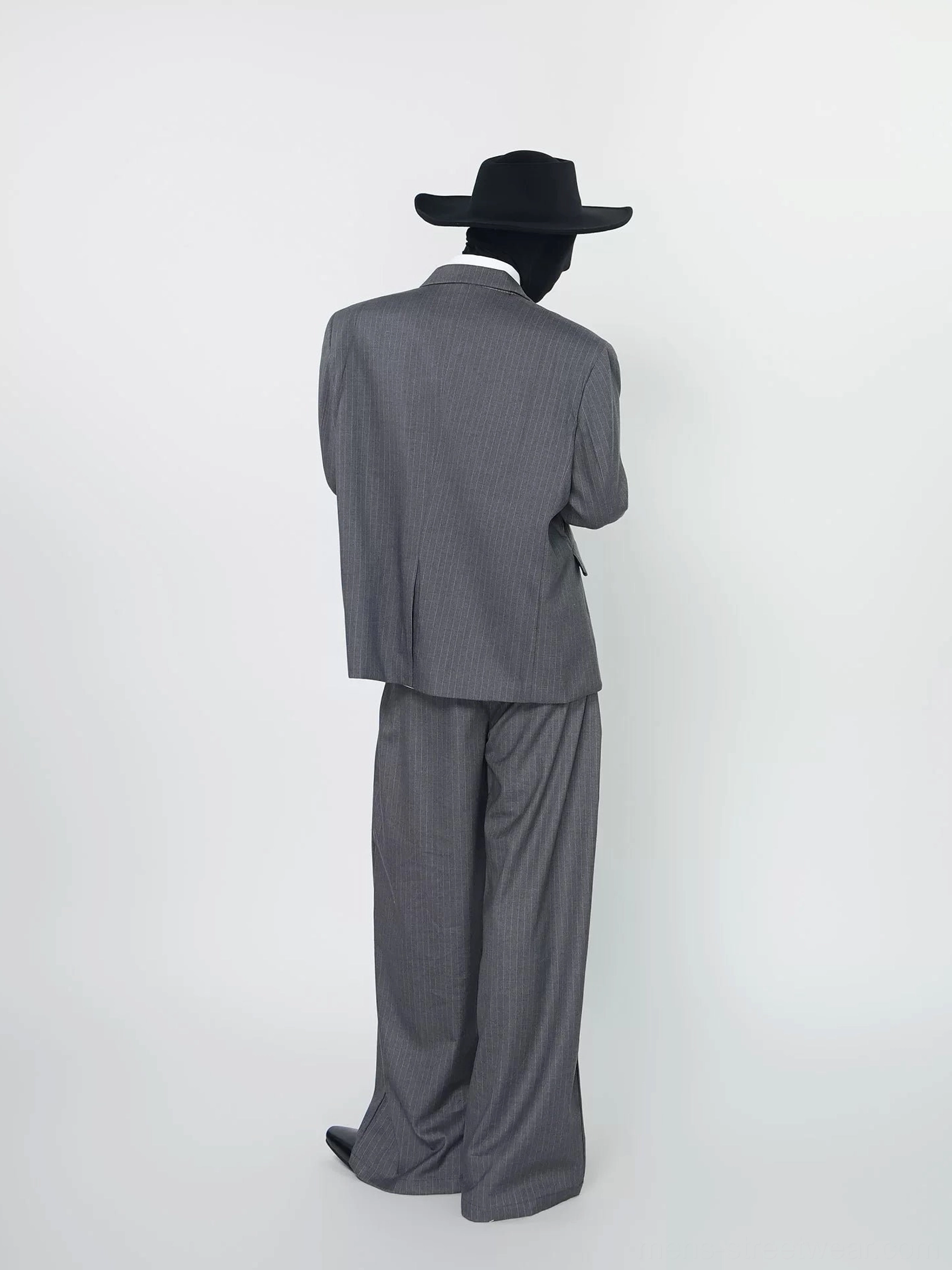 Back view of gray pinstripe double-breasted suit set with relaxed blazer and high-waisted wide-leg trousers