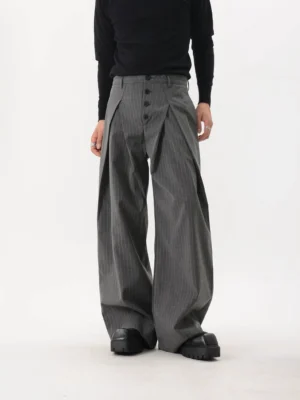 Gray pinstripe double-pleated ultra-wide leg trousers shown from a low front angle with button-front waistband and draped straight-leg silhouette