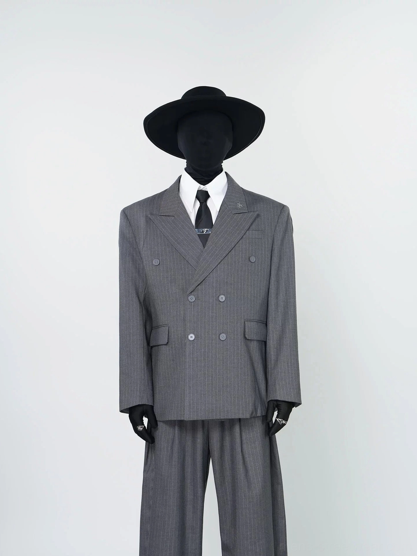 Gray pinstripe two-piece suit with notched lapels double-breasted buttons and high-waisted wide-leg pants front view