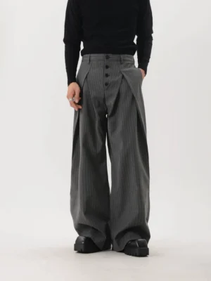 Gray pinstripe wide-leg tailored trousers styled with a black turtleneck and chunky leather shoes, front view with double pleats