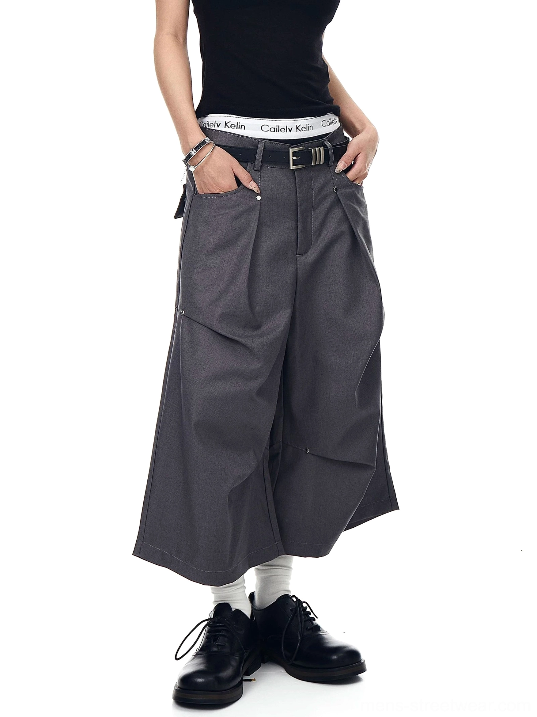 Gray pleated tailored longline shorts with roomy wide legs and side pockets in a contemporary Seoul fashion outfit
