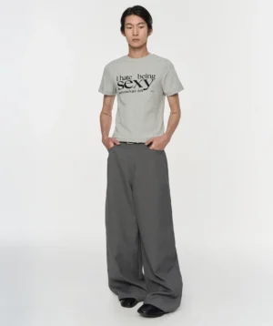 Gray pleated wide-leg suit trousers styled with a printed tee, showing the relaxed draped fit and modern Seoul fashion silhouette