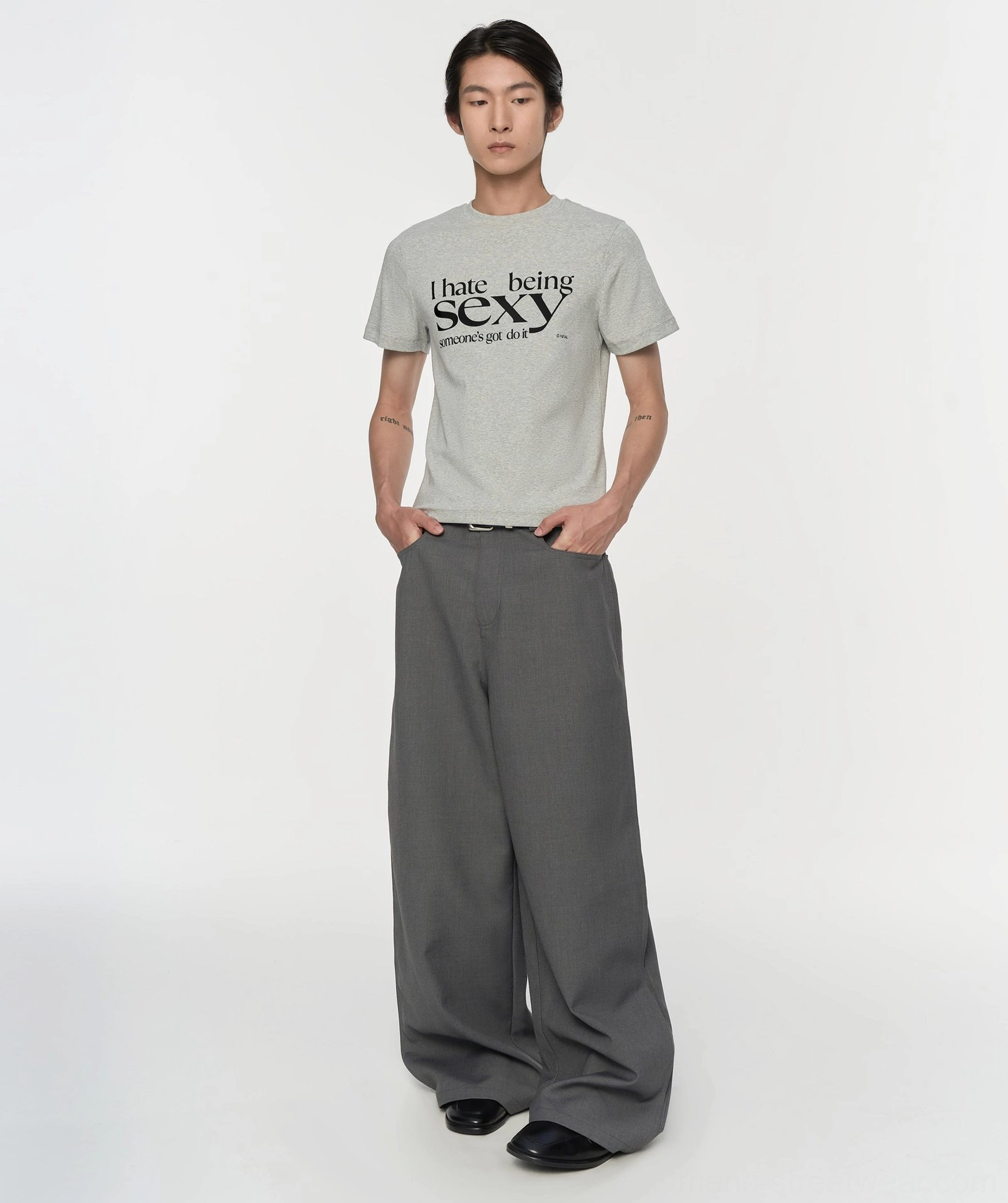 Gray pleated wide-leg suit trousers styled with a printed tee, showing the relaxed draped fit and modern Seoul fashion silhouette