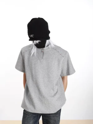 Heather gray studded half-zip relaxed fit streetwear T-shirt for men shown from the back with metallic shoulder studs