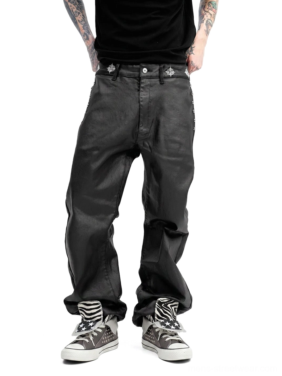 Full lower-body streetwear styling with gray studded zebra high-top sneakers, black short sleeve shirt, black leather pants, and matching socks