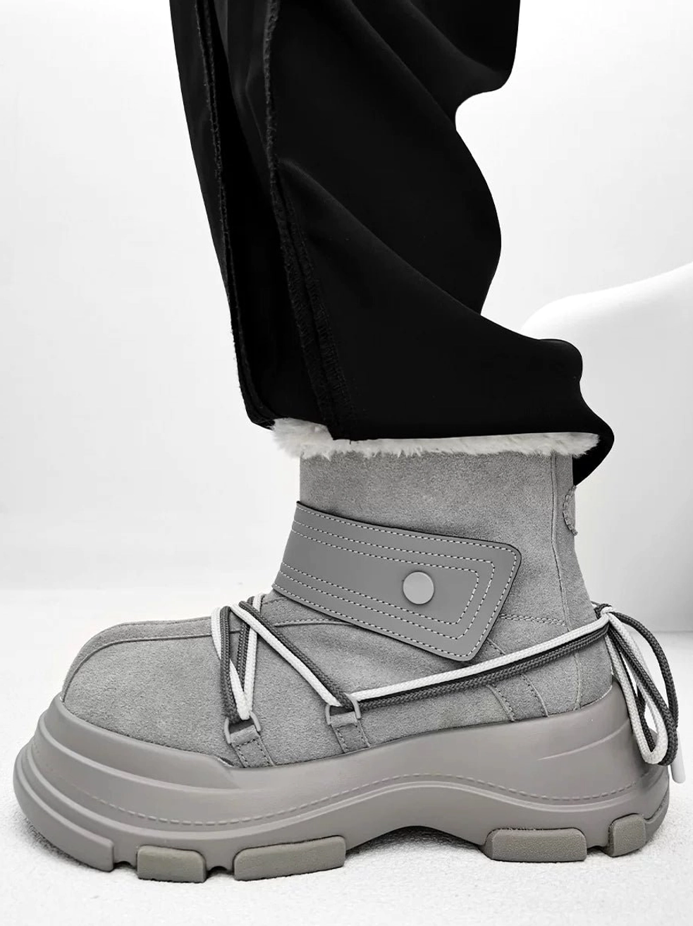 Gray suede-finish shearling platform winter boots with white faux-fur cuff and oversized chunky tread sole in side view