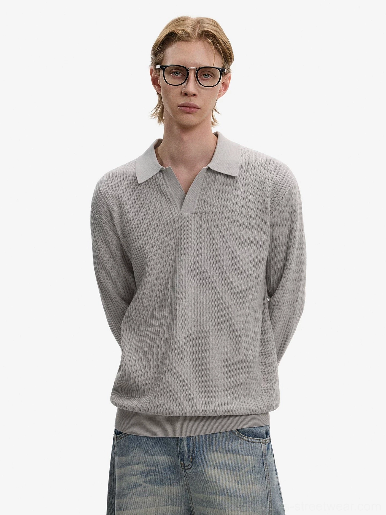 Gray waffle knit Johnny collar long sleeve polo sweater styled with washed blue wide-leg denim in a minimalist studio streetwear look