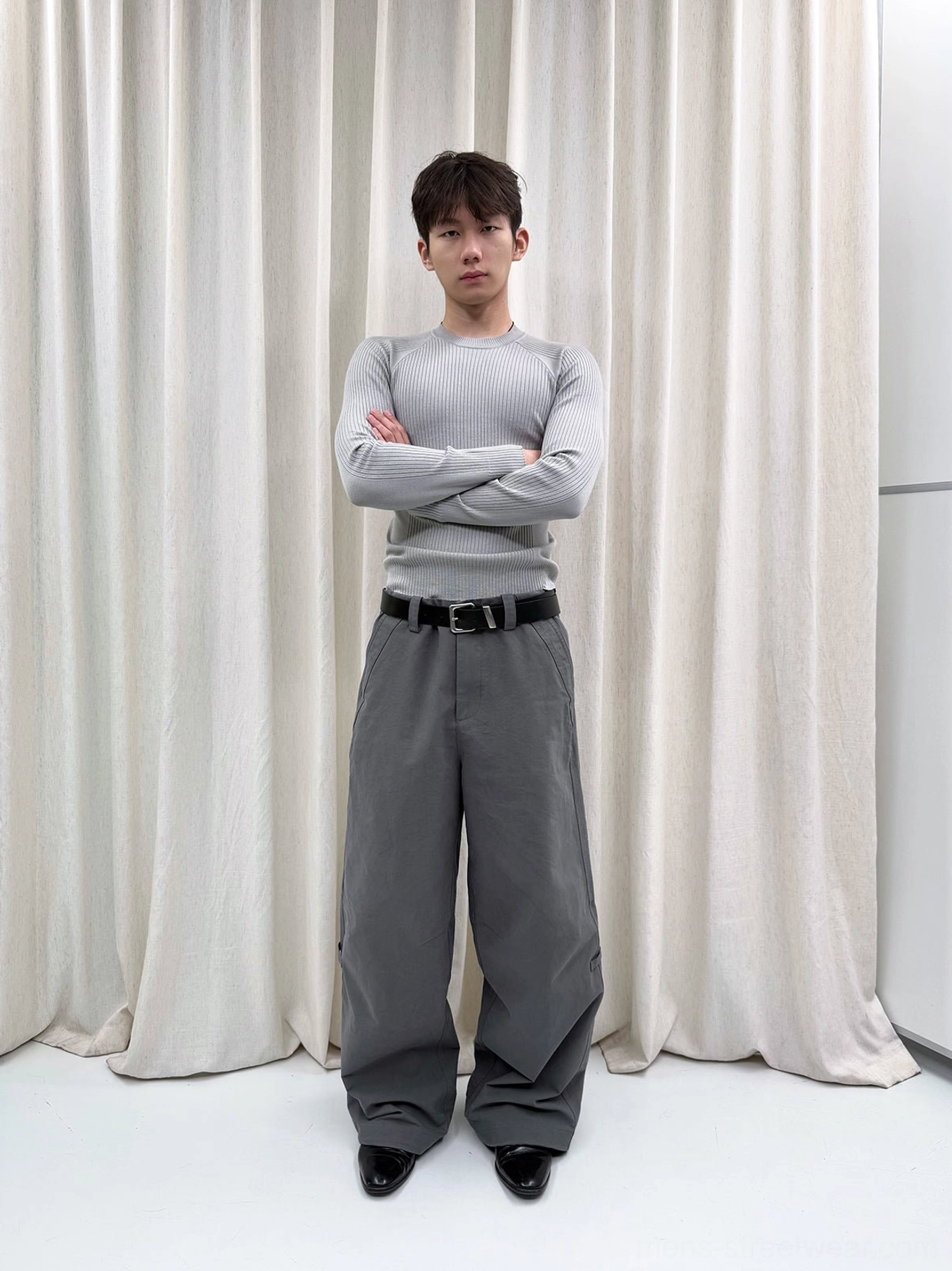 Gray washed wide-leg trousers shown in a full front studio outfit with a fitted gray top and contemporary Korean fashion styling