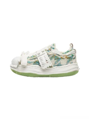 Green frayed tweed sculpted-sole platform sneaker in left side view with mixed textile panels, oversized laces, white shell toe and lime green outsole