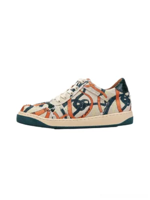 Green graffiti canvas low-top sneakers shown in a side three-quarter product view with multicolor abstract artwork, off-white laces, dark green rubber outsole, and classic streetwear court silhouette