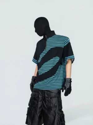 Left three-quarter view of a green teal and black half-zip striped tech tee with curved wave color blocking, mock neck, wide sleeves, and relaxed Korean streetwear fit