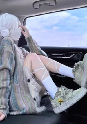 Green Longjing tea star sneakers styled with white crew socks and a striped knit cardigan in a casual streetwear outfit