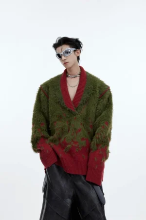 Green and wine red gradient shaggy V-neck knit sweater styled with wide-leg leather pants, sunglasses, and layered necklaces in a minimalist studio