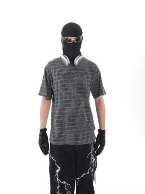 Front view of a grey and black striped streetwear T-shirt with embroidered chest lettering, relaxed drop shoulders, and distressed urban styling