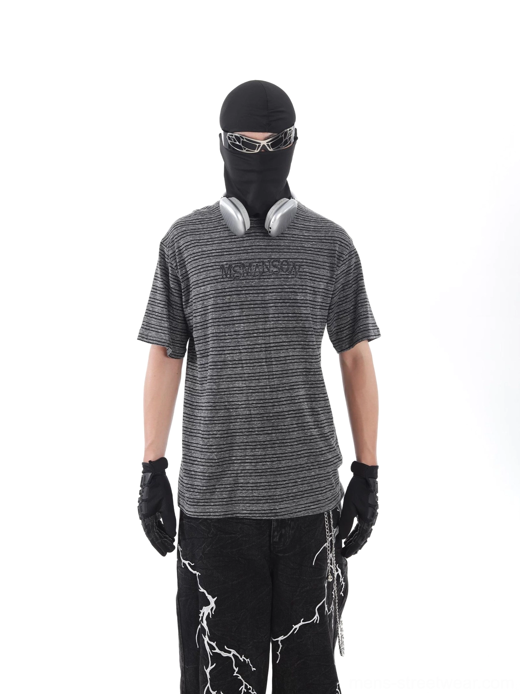 Front view of a grey and black striped streetwear T-shirt with embroidered chest lettering, relaxed drop shoulders, and distressed urban styling