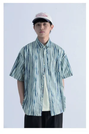Grey blue abstract vertical stripe short sleeve streetwear shirt with button-down collar chest pocket and relaxed drop shoulder fit