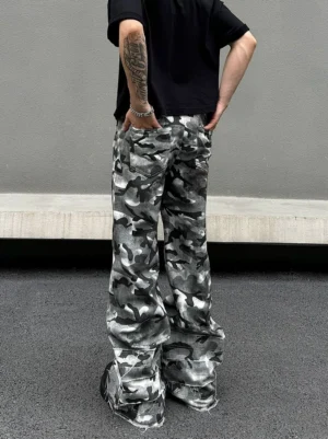 Rear view of grey camouflage slouch cargo pants showing the oversized wide-leg silhouette, back pockets, stacked fit, and raw frayed hems
