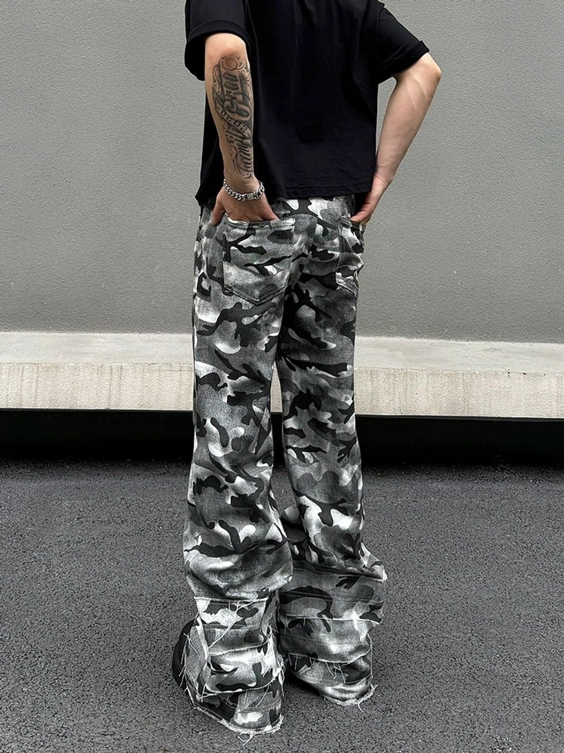Rear view of grey camouflage slouch cargo pants showing the oversized wide-leg silhouette, back pockets, stacked fit, and raw frayed hems