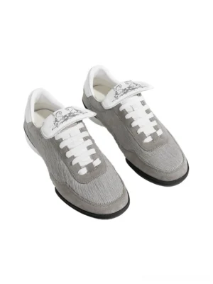 Pair of grey fur-lined platform sneakers shown from above with fuzzy uppers, white laces, decorative printed tongues, and chunky black soles