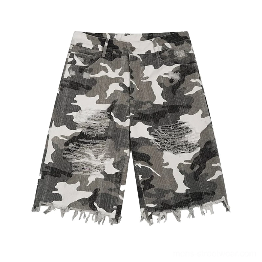 Flat lay front view of grey-green-white camouflage cutoff denim shorts with shredded front thighs, five-pocket construction, wide-leg fit, and raw frayed hem
