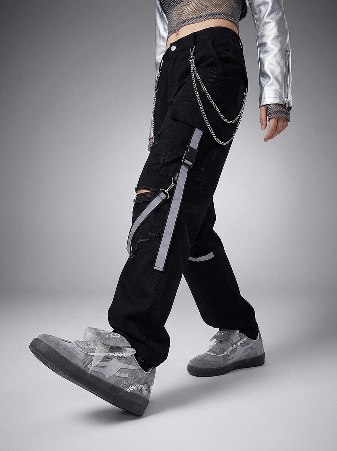 Grey lace-wrapped retro trainer sneakers styled with cargo pants and silver Y2K streetwear outerwear