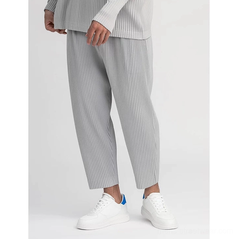Grey men's pleated streetwear top with relaxed boxy proportions and matching pleated trouser styling