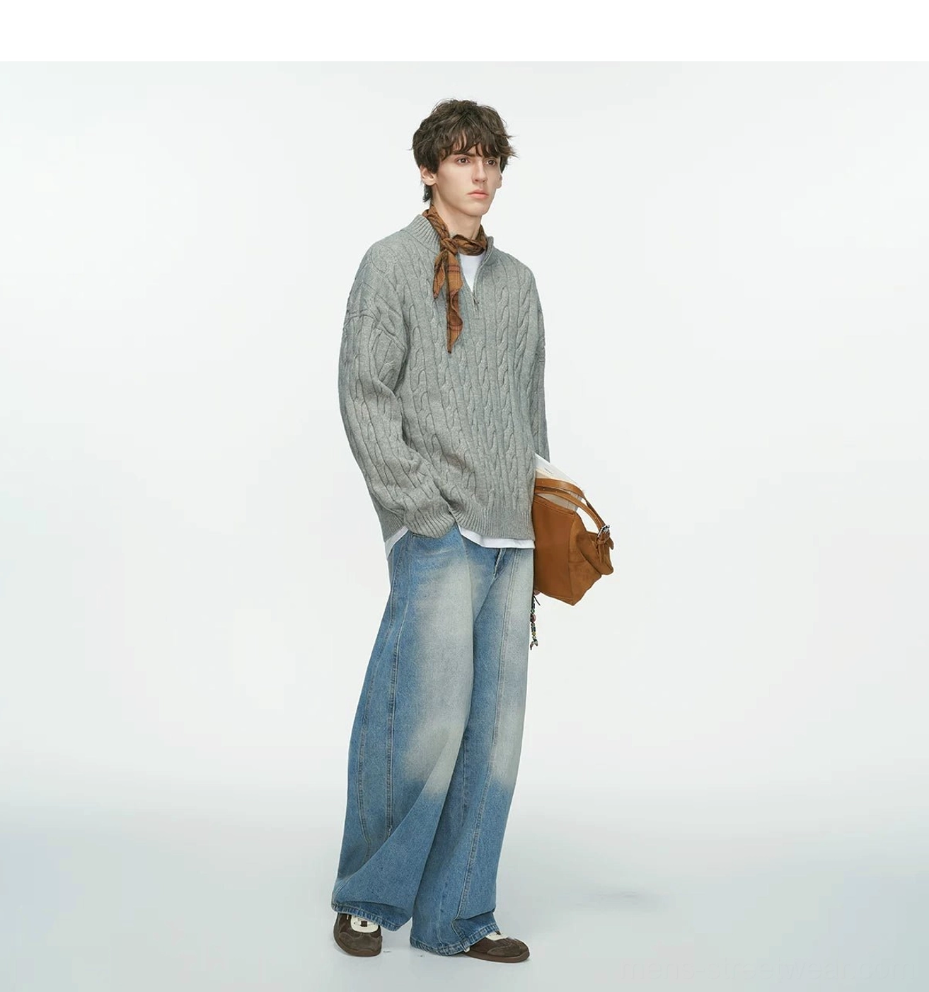 Grey oversized cable-knit half-zip sweater with brown shoulder bag, light wash jeans and plaid scarf styling