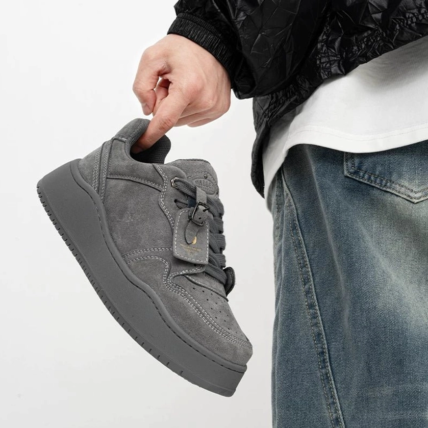 Grey suede low-top platform skate sneaker shown from a side three-quarter angle with tonal rubber sole and casual streetwear styling