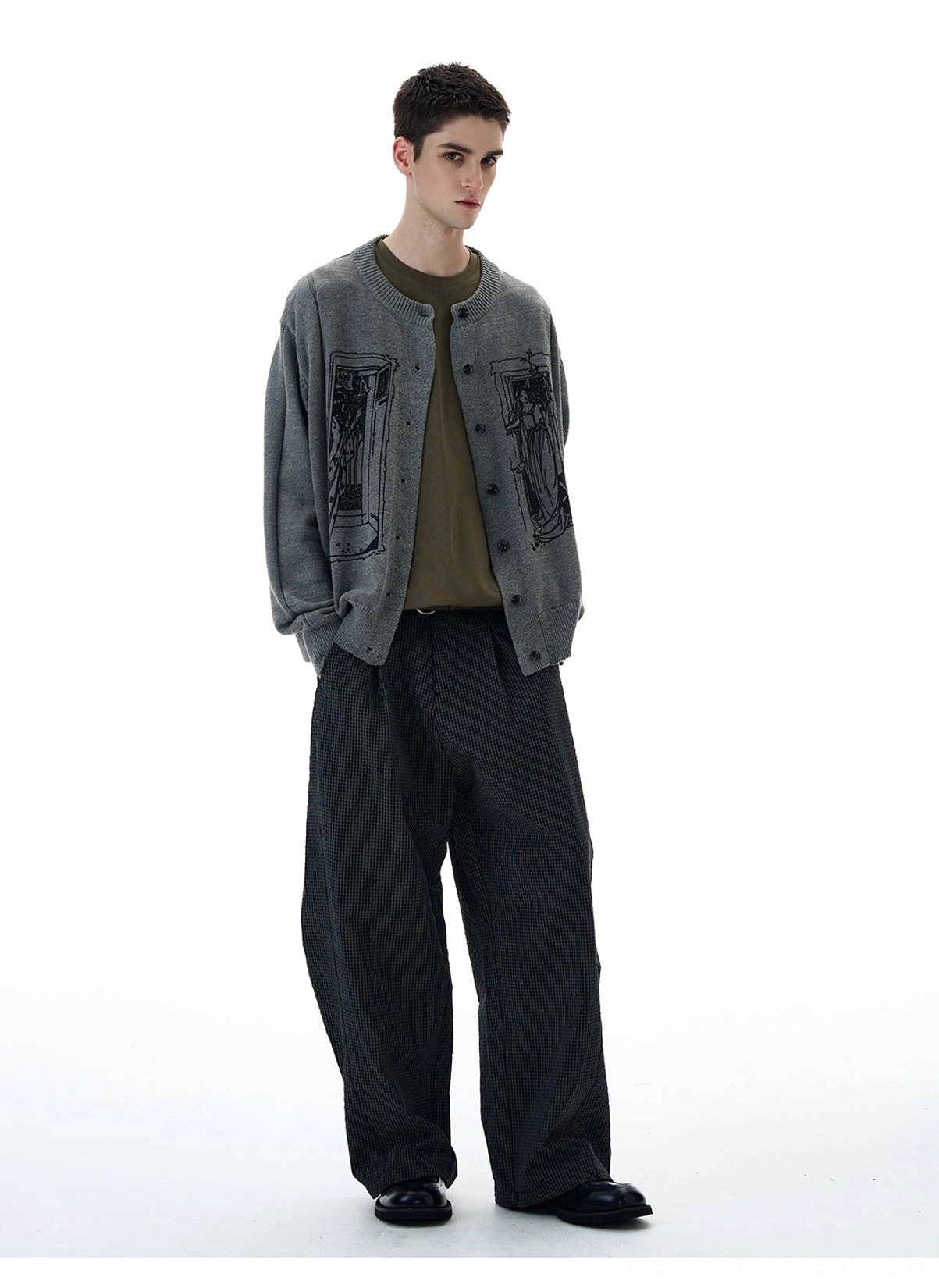 Full front view of relaxed grey tarot graphic button-up knit cardigan styled with dark wide-leg trousers