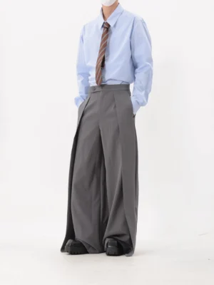 Grey wide-leg pleated tailored trousers shown from the front with high waist, smooth drape, and practical pockets