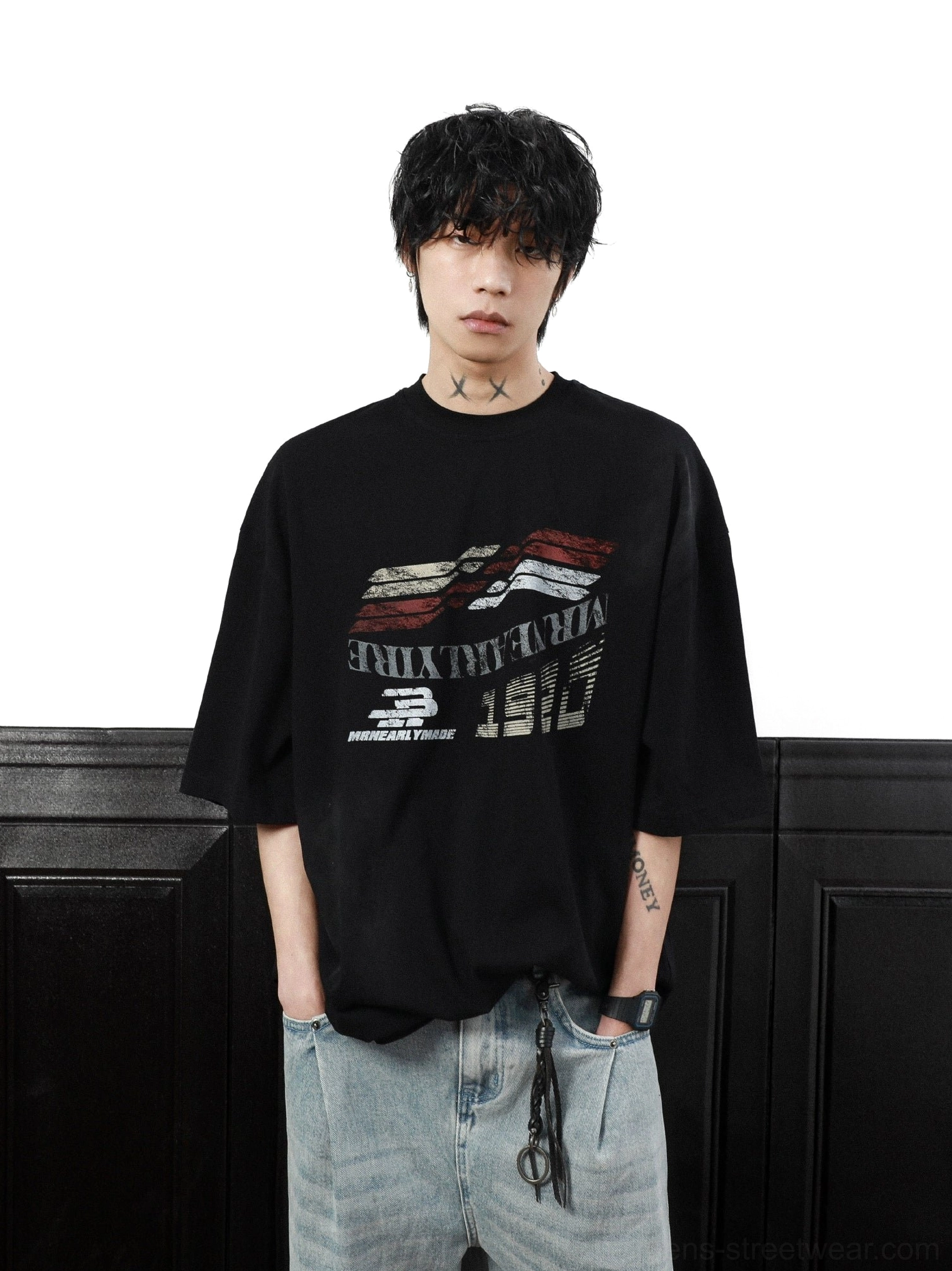 Upper-body view of black retro motorsport graphic T-shirt showing distressed racing print, drop shoulders, and loose short sleeves