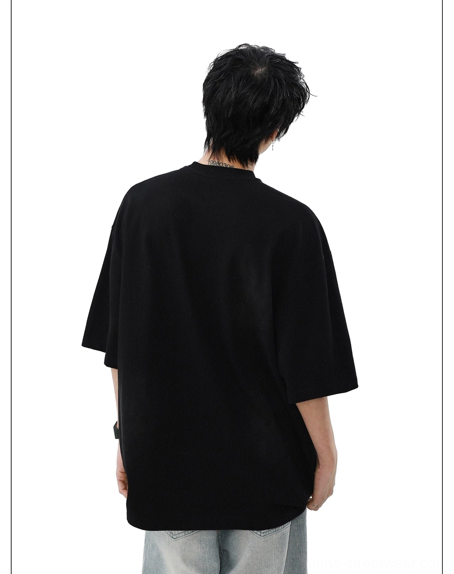Back view of the black Gridline Drift oversized T-shirt showing its clean solid back and loose streetwear silhouette