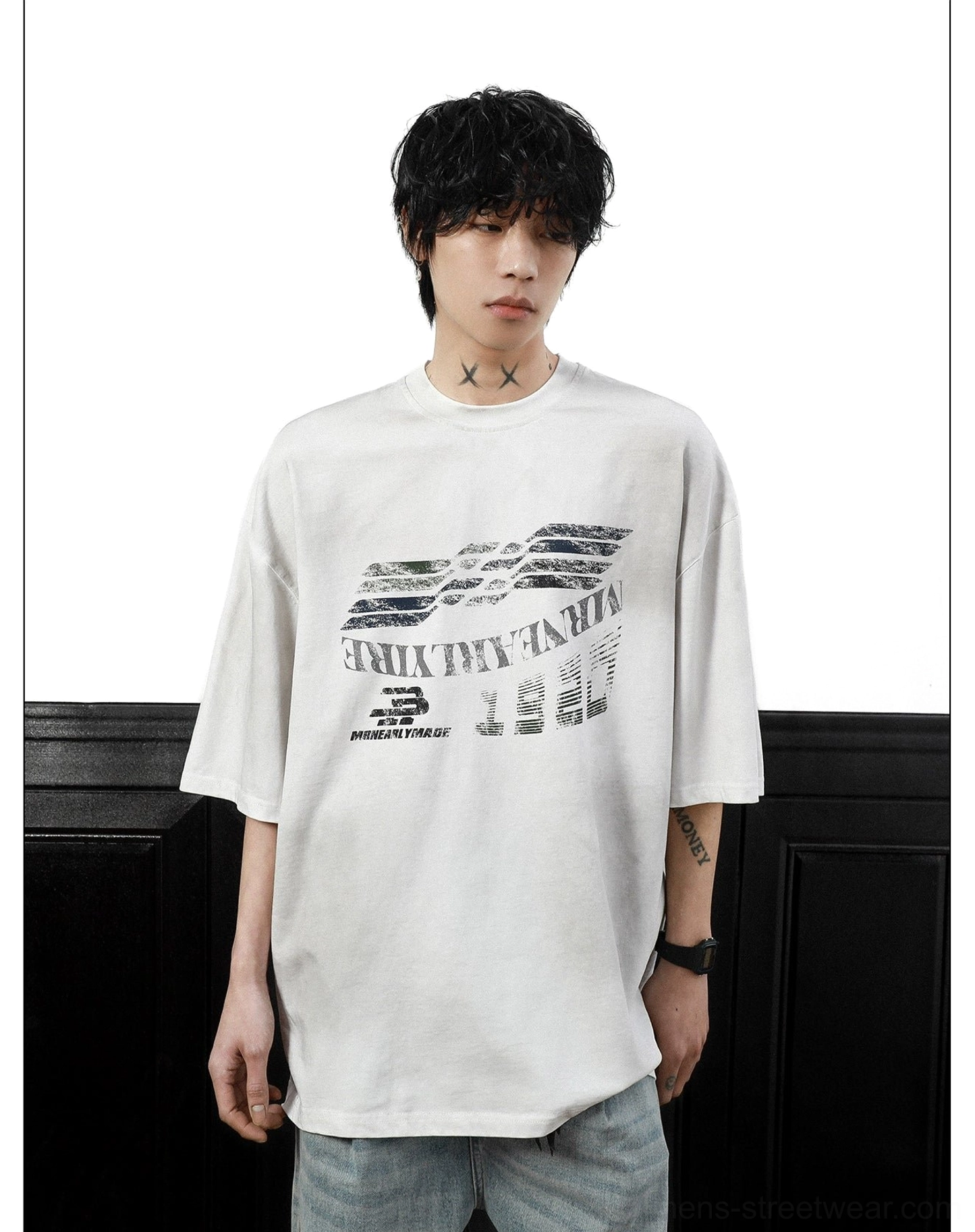 Full-body streetwear styling featuring an oversized Gridline Drift racing graphic tee, relaxed fit, and light-wash baggy jeans