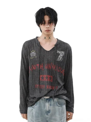 Front view of a male model wearing a charcoal grey grunge ribbed knit henley top with red vintage varsity graphics and number 7, styled with light wash wide-leg jeans